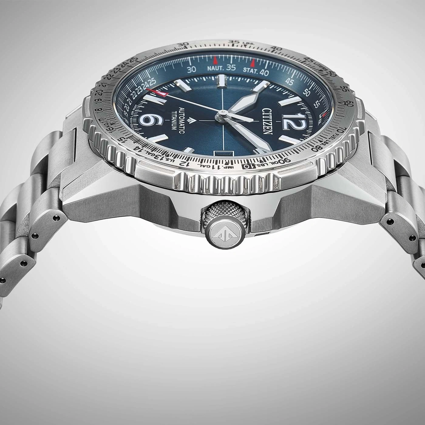 A close-up shot of a Citizen automatic titanium watch with a blue dial and metal bracelet.