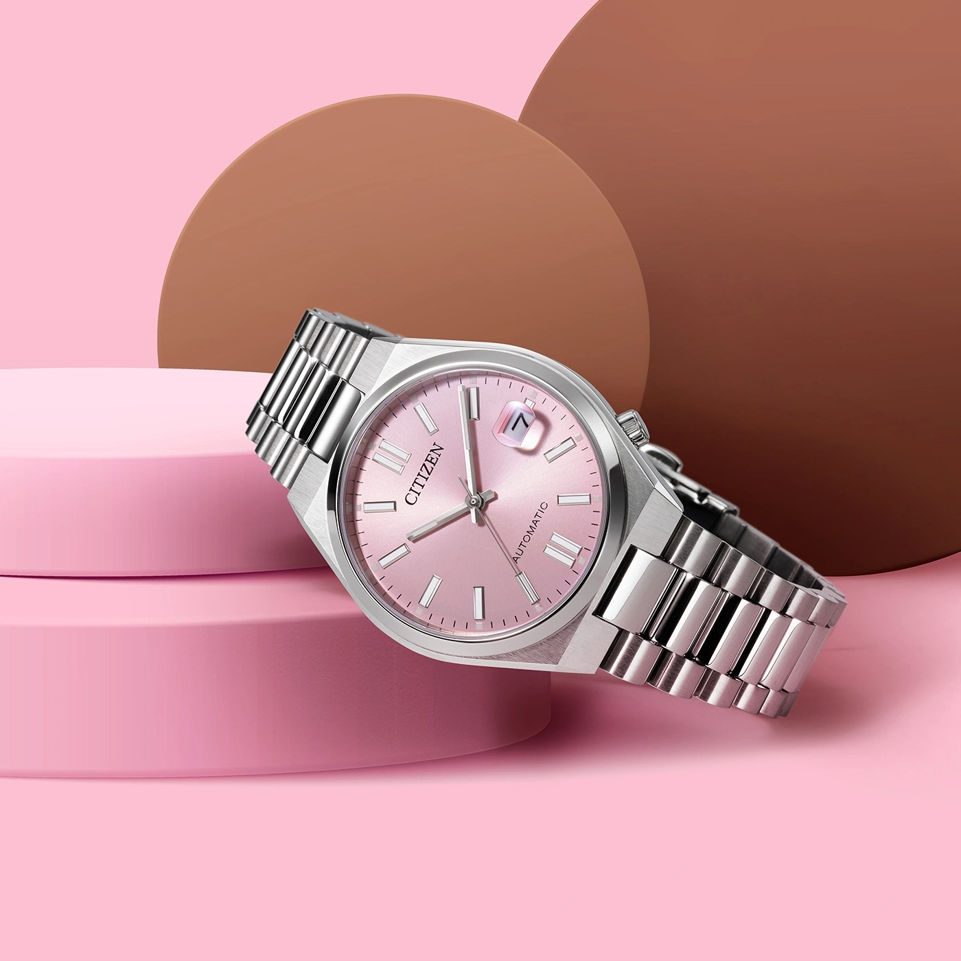 Citizen watch with pink face and silver band on pink background