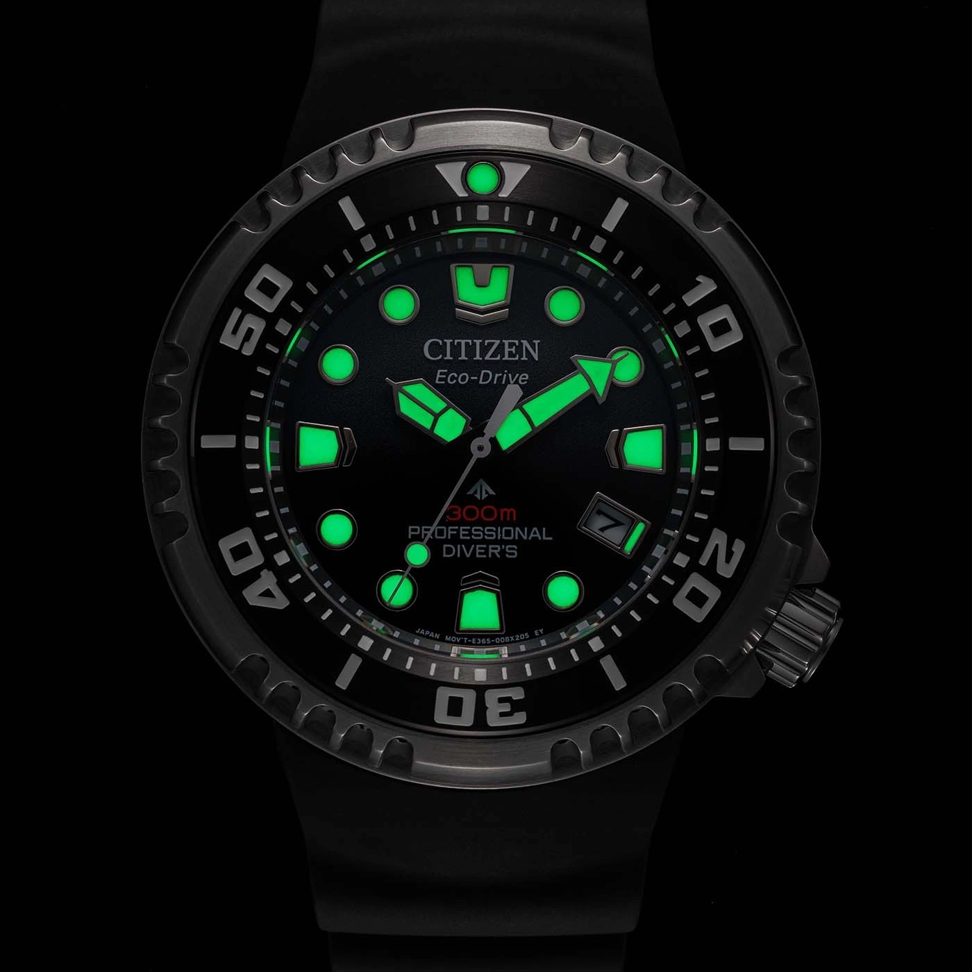 Citizen Eco-Drive watch with glowing green accents and black background.