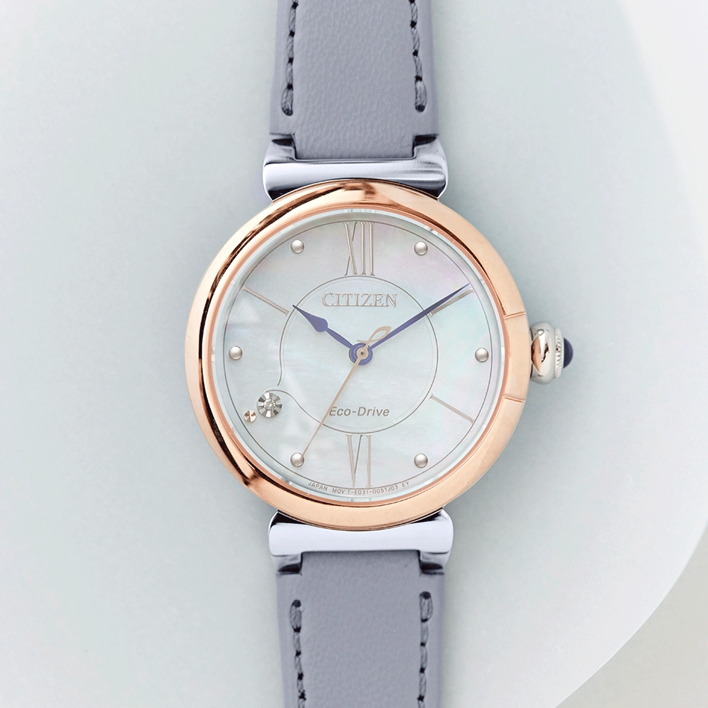 Citizen watch with a rose gold bezel and grey leather strap
