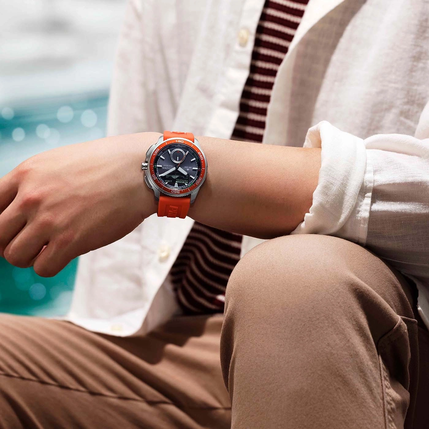 Man wearing a Citizen Eco-Drive watch with an orange strap.