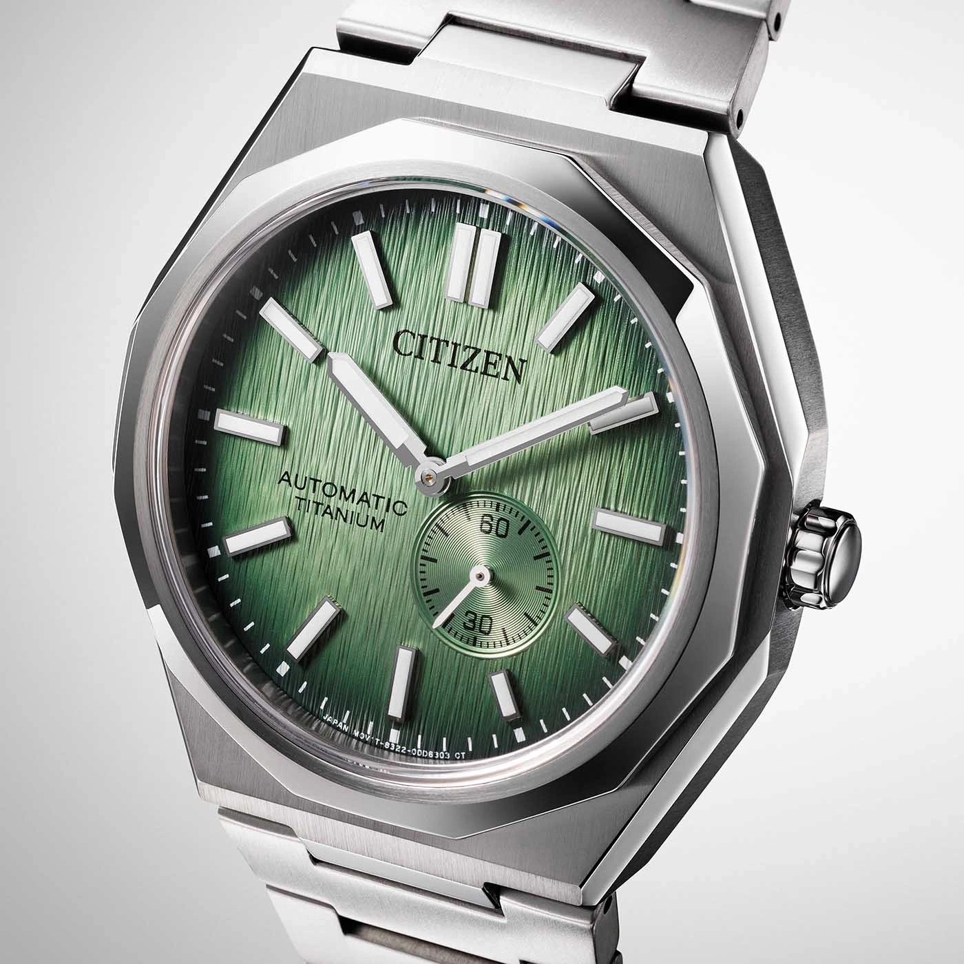 Citizen watch with green face and titanium strap, automatic movement.
