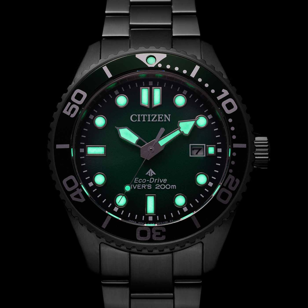 Citizen Eco-Drive Diver's watch with green luminous dial and black bracelet.