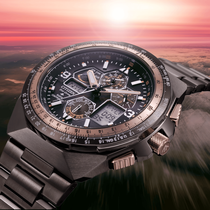 Citizen watch with multiple dials and a complex design, set against a sunset backdrop.