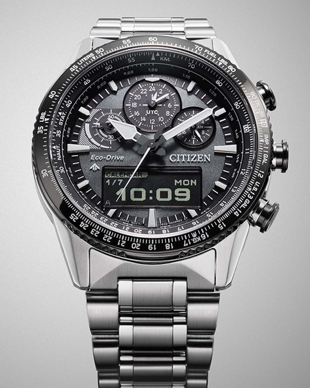 Citizen watch with multiple dials, digital display, and stainless steel band.