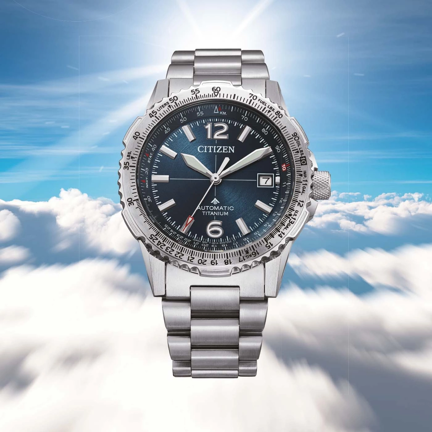 A Citizen watch with a blue dial and silver band floats in the sky.
