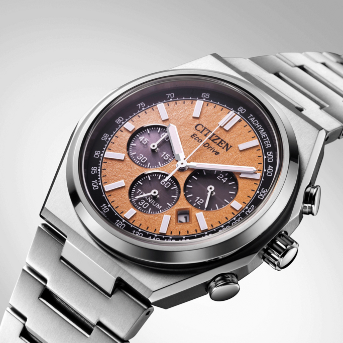 Citizen watch with orange face, titanium, chronograph, Eco-Drive, and tachymeter.
