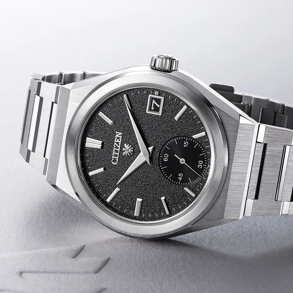 Citizen watch with black dial and silver bracelet, elegant design.