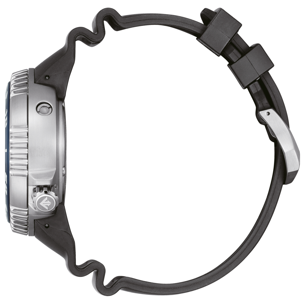 Side view of a silver watch with a black rubber strap on a green background.