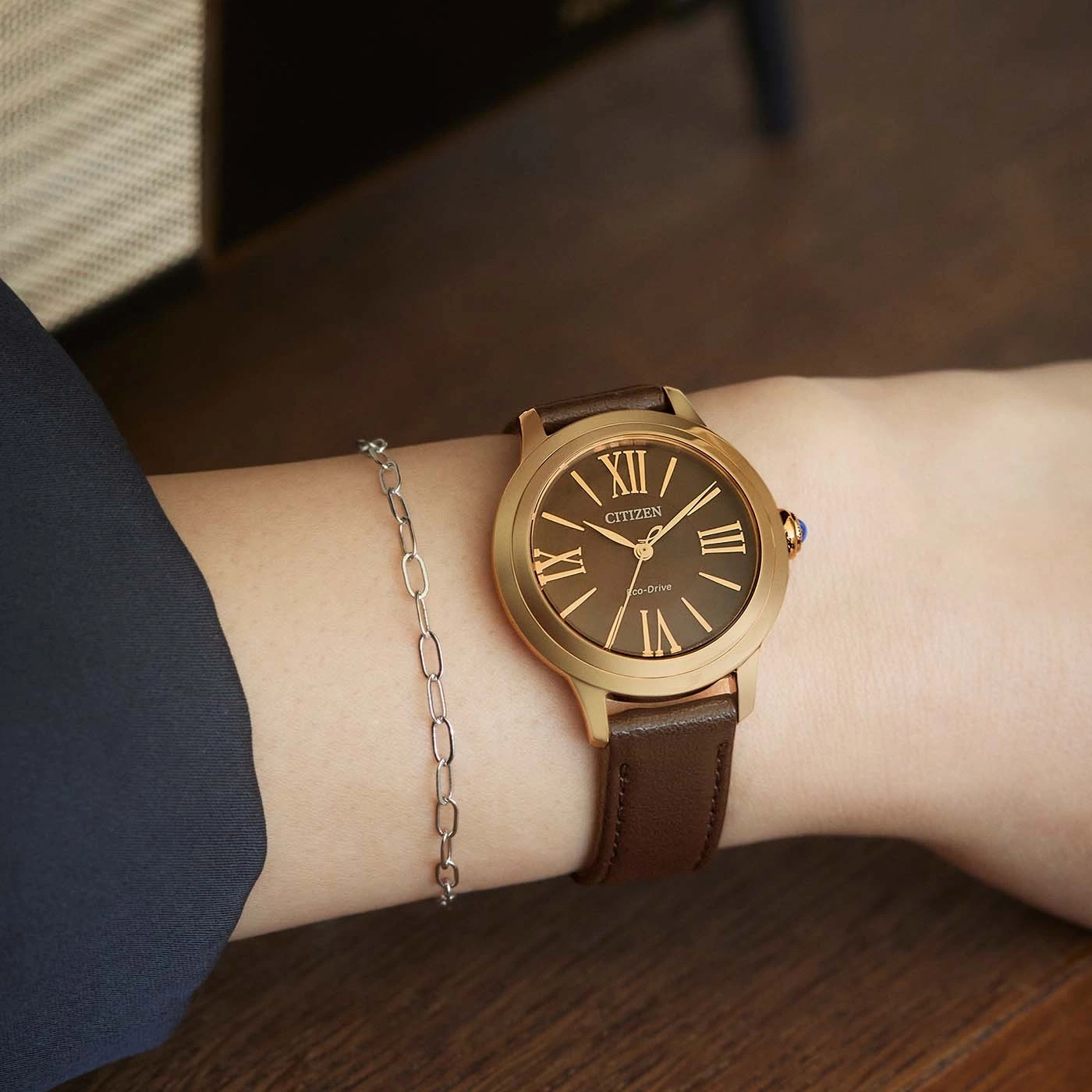 Wrist with watch and bracelet. Brown leather strap. Citizen watch.