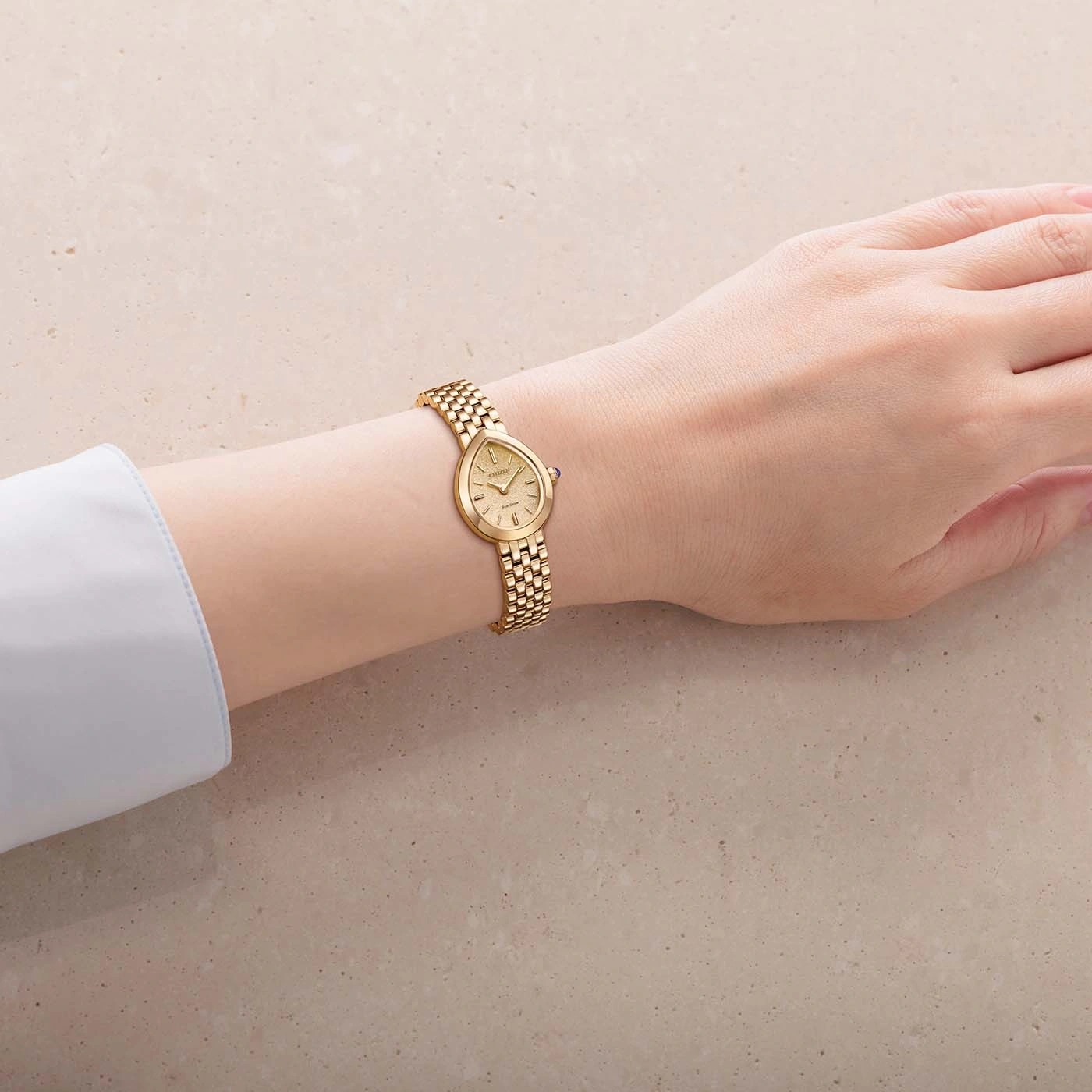 A gold watch on a woman's wrist