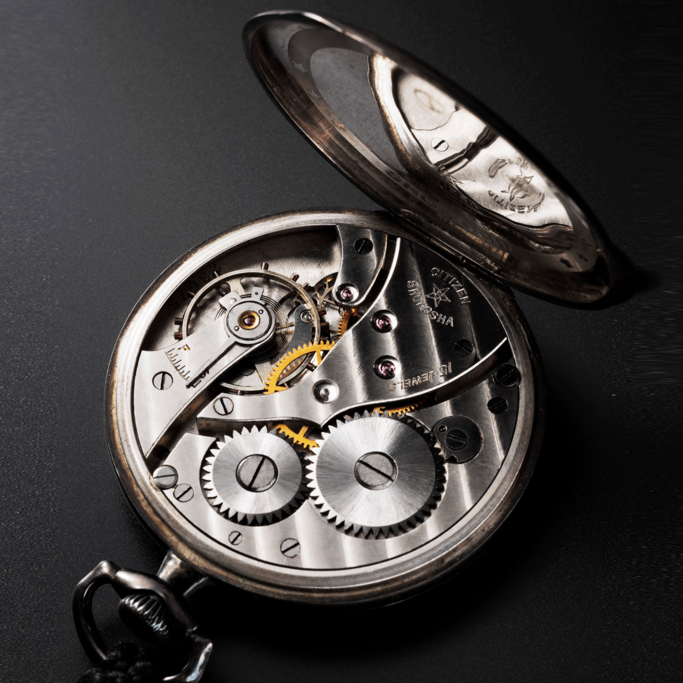 Close-up of a Citizen Shokosha pocket watch with intricate gears and details.