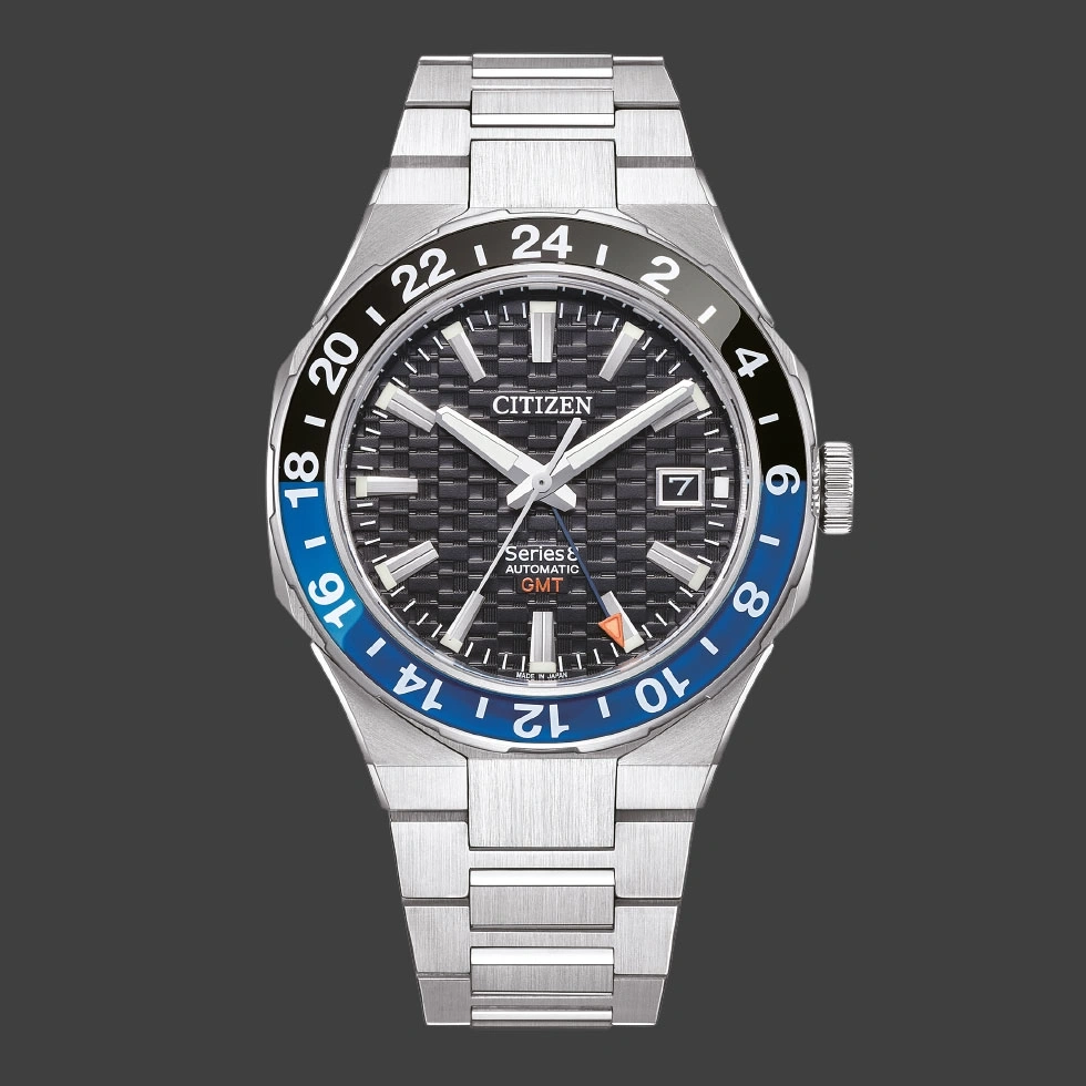 Citizen watch with black and blue bezel, GMT function, and stainless steel bracelet.