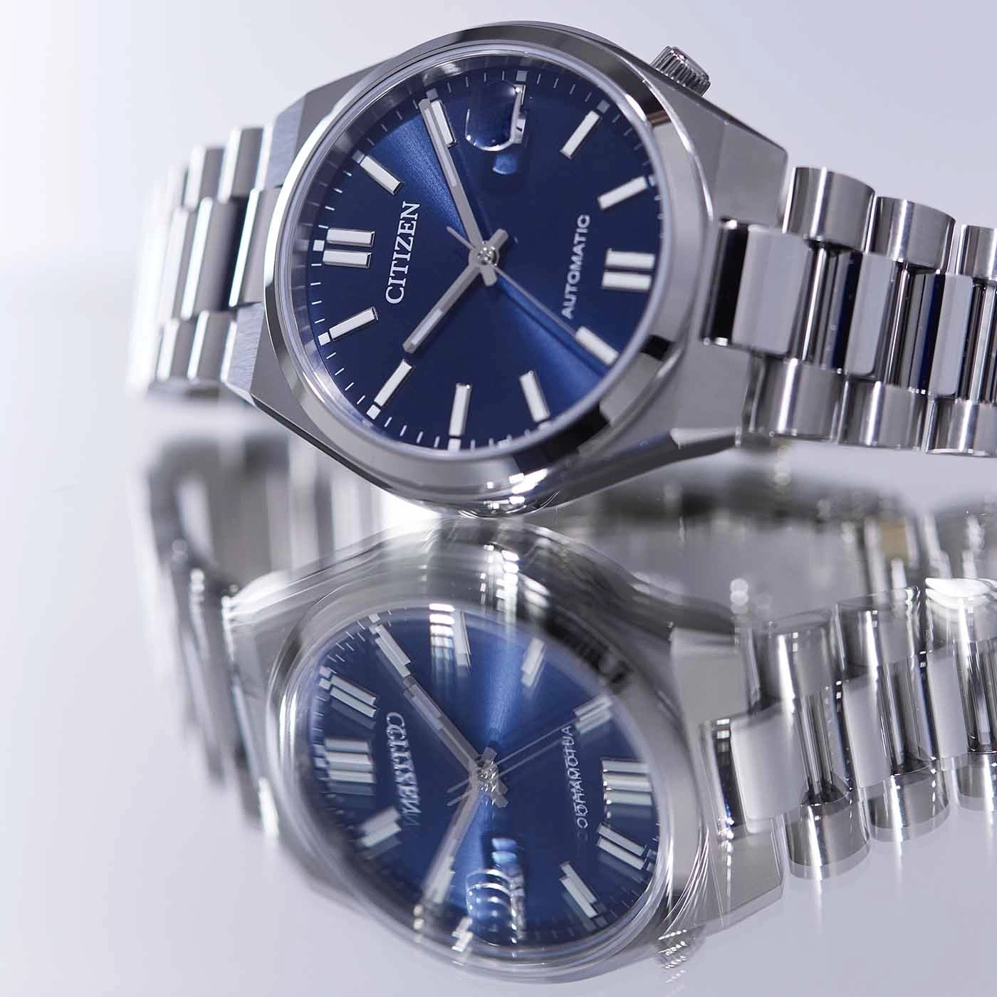 Citizen watch with blue face and silver band, automatic movement.