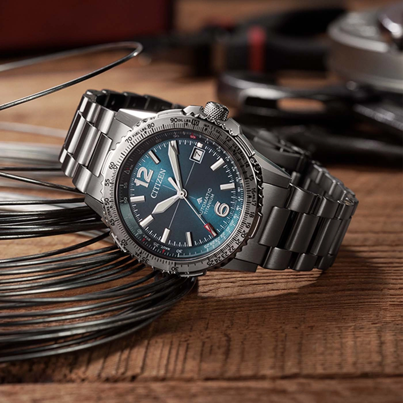Citizen automatic titanium watch with blue dial on a metal band.