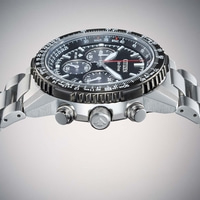 Close-up of a Citizen Eco-Drive watch with a black dial and metal band.