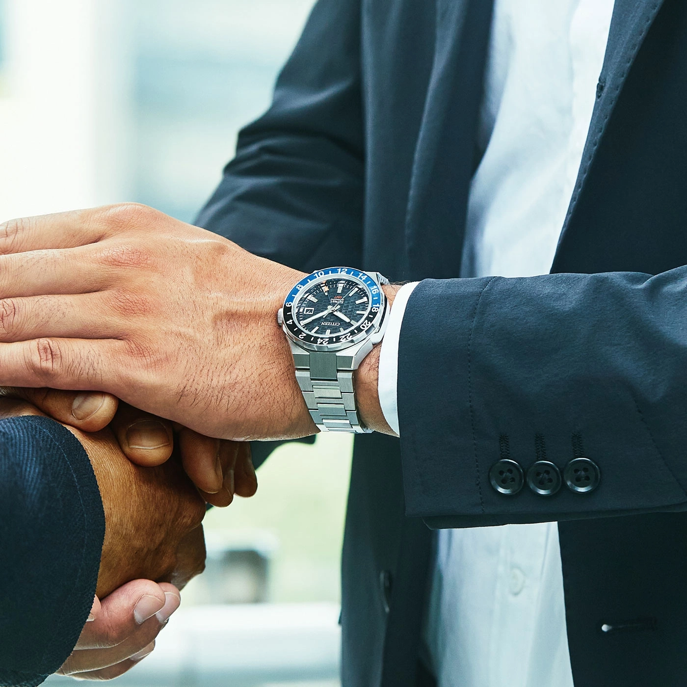 Man wearing a watch shaking hands, business deal, close-up shot.