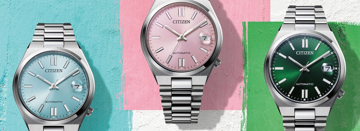 Three Citizen watches with different colored faces and metal straps.