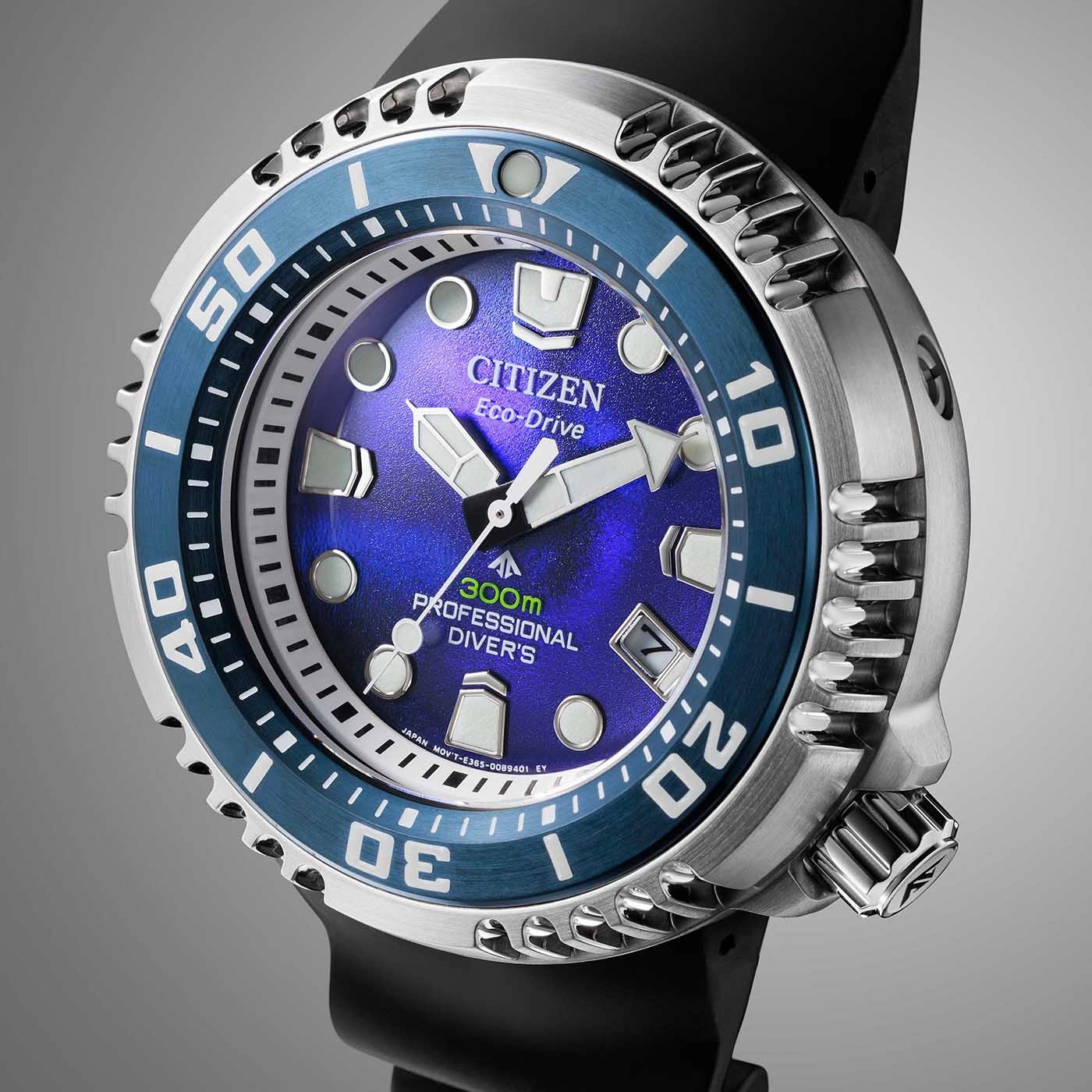 Citizen Eco-Drive watch with blue dial and bezel, black strap, and silver case.
