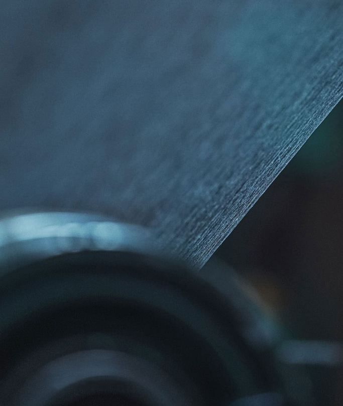 Close-up of a textured surface with a blurred background and dark tones.