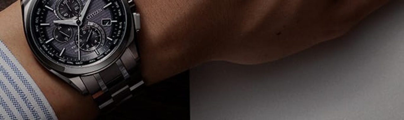 Close-up of a Citizen watch on a wrist, showing the watch face and band.