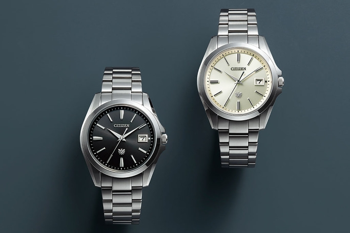 Two Citizen watches with silver bands and different colored faces.