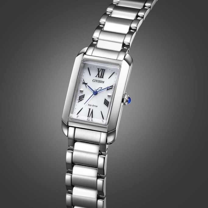 Citizen watch with a white face and silver band on a gray background