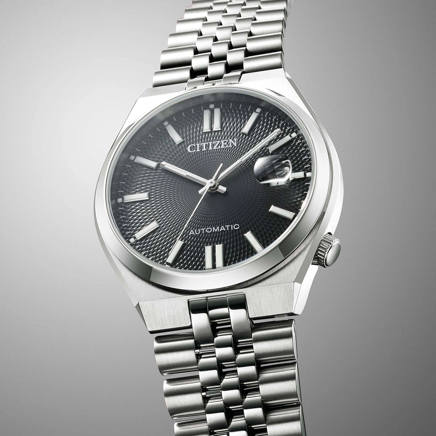 Citizen watch with a black dial and silver bracelet, automatic movement.
