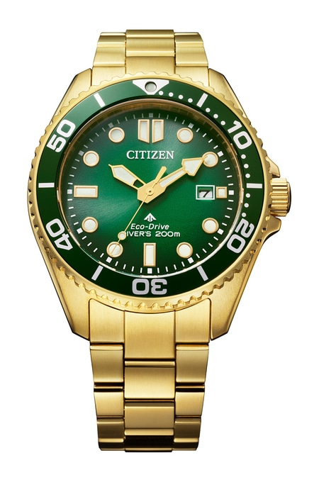 Gold Citizen watch with green dial and bezel, a stylish timepiece.