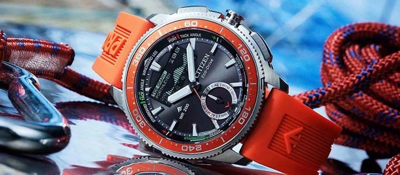 Close-up of a Citizen Eco-Drive watch with an orange strap and nautical details.