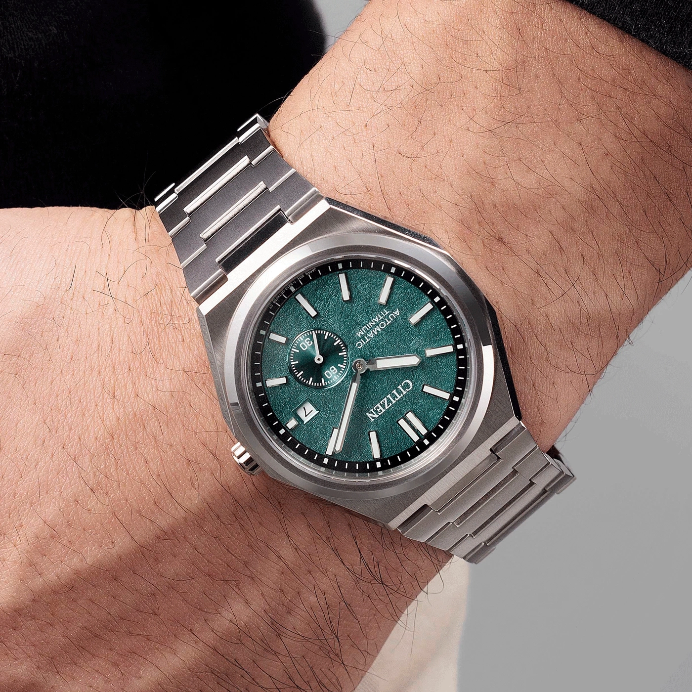 Citizen watch on wrist, green dial, titanium, automatic, close-up shot