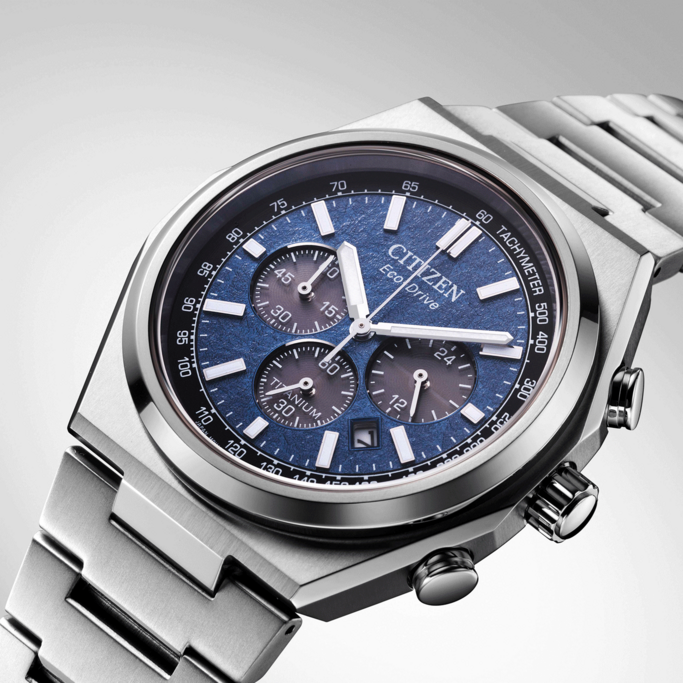 Citizen Eco-Drive watch with blue face and titanium band, chronograph design.