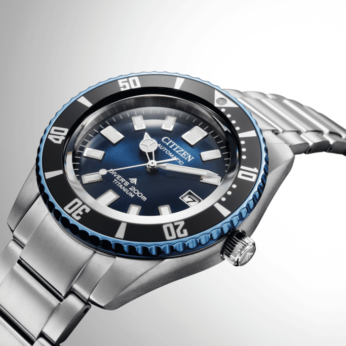 Citizen watch with blue dial and titanium bracelet, close-up shot.