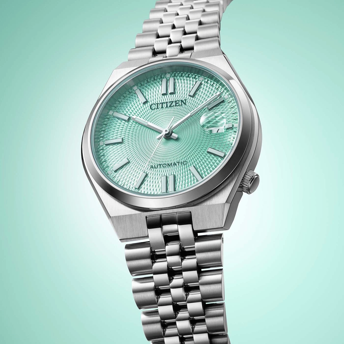 A silver Citizen watch with a green textured dial.