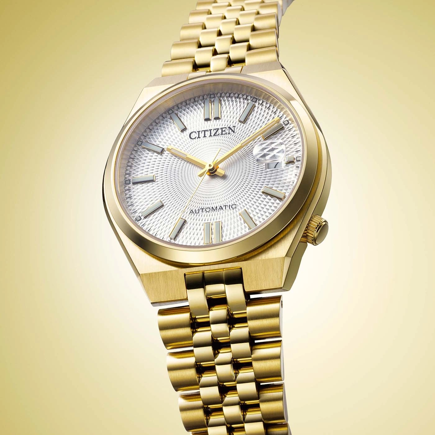 A close-up shot of a luxurious gold Citizen automatic watch.