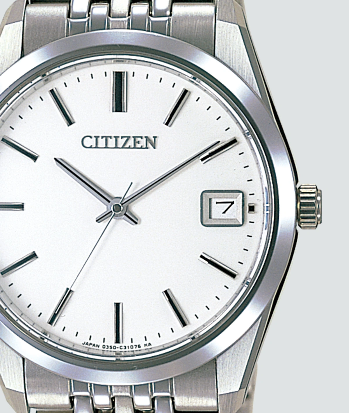 Close-up of a Citizen watch with a white face and date display.