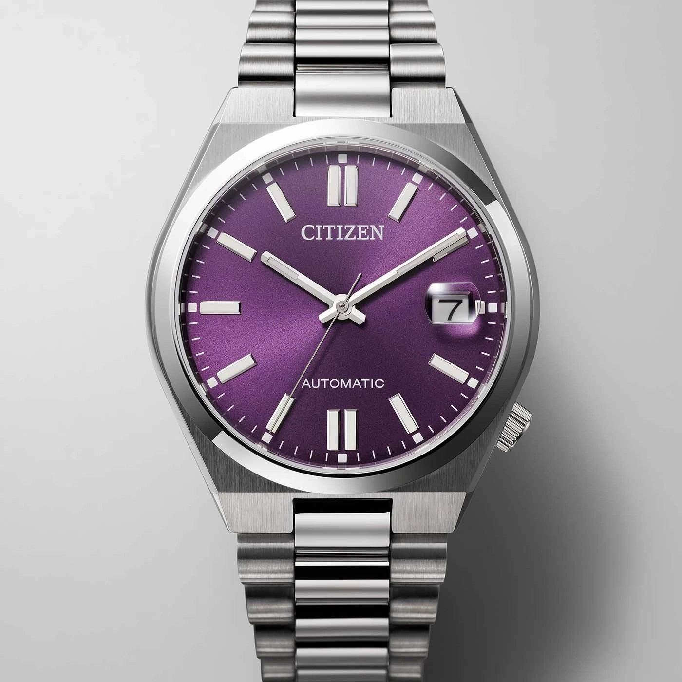 Citizen watch with purple face and silver band, automatic.