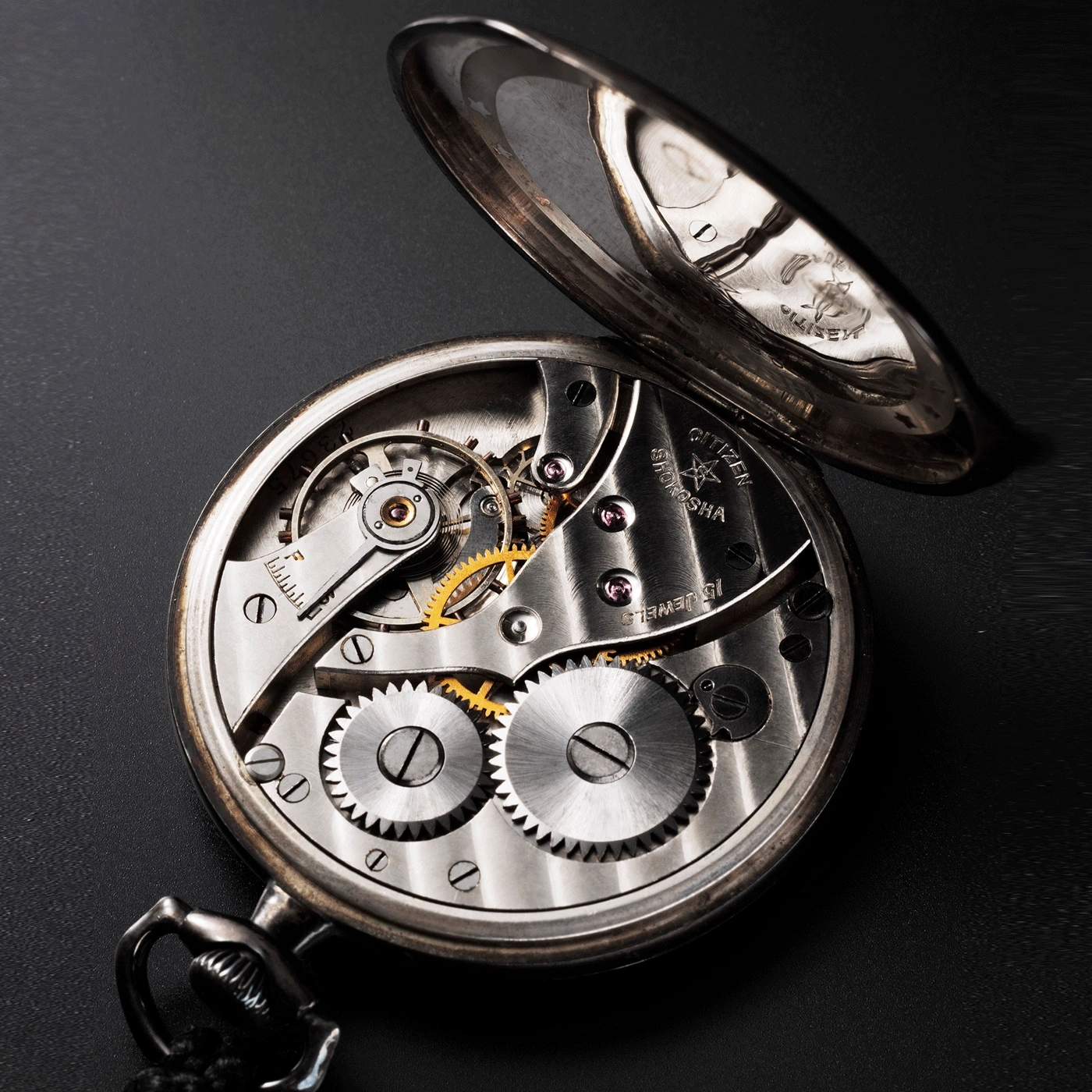 Close-up of a Citizen Shokosha pocket watch with intricate gears and details.
