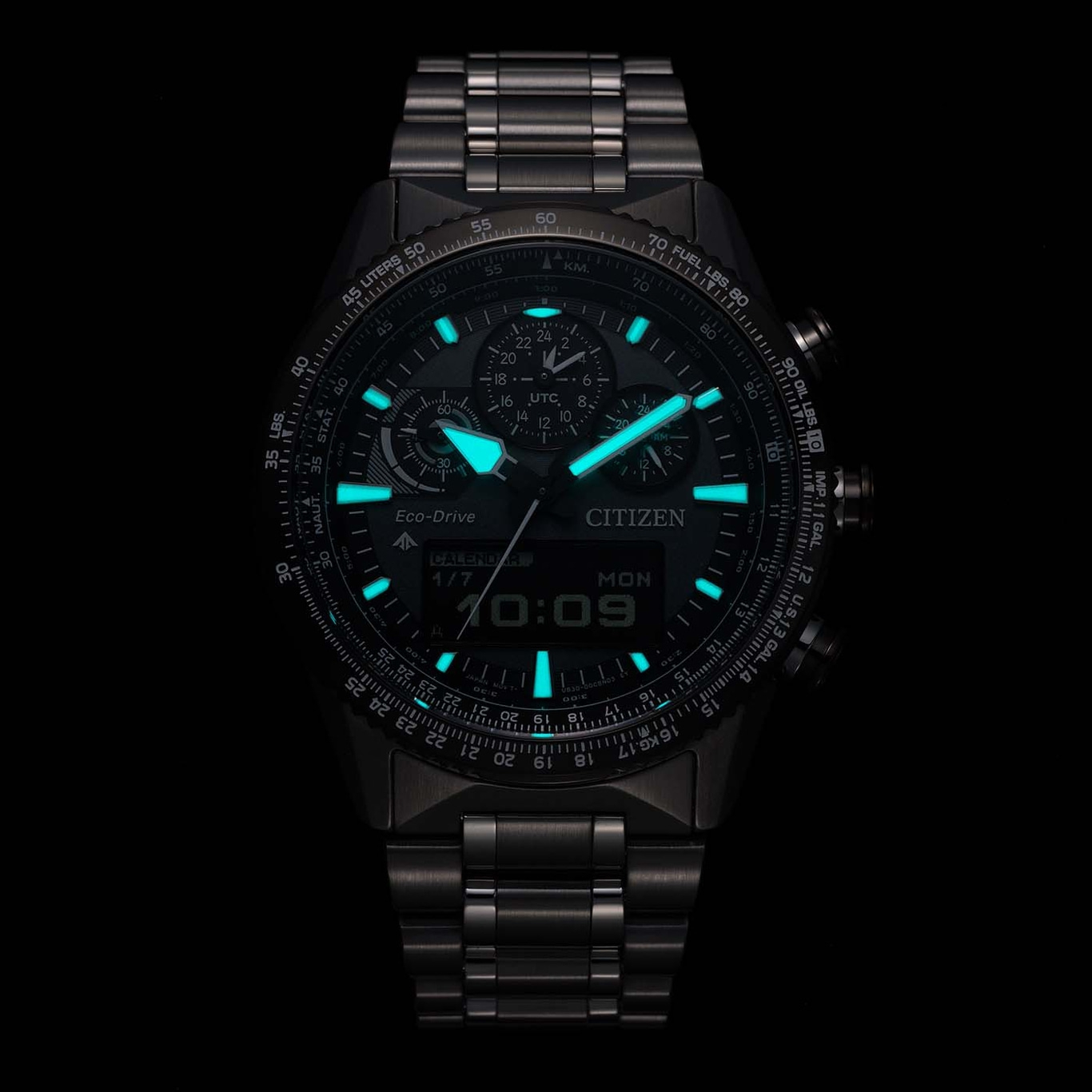Citizen watch with glowing features, calendar, and time display on a black background.