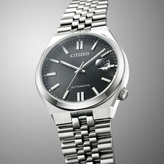 Citizen watch with a black dial and silver bracelet, automatic movement.