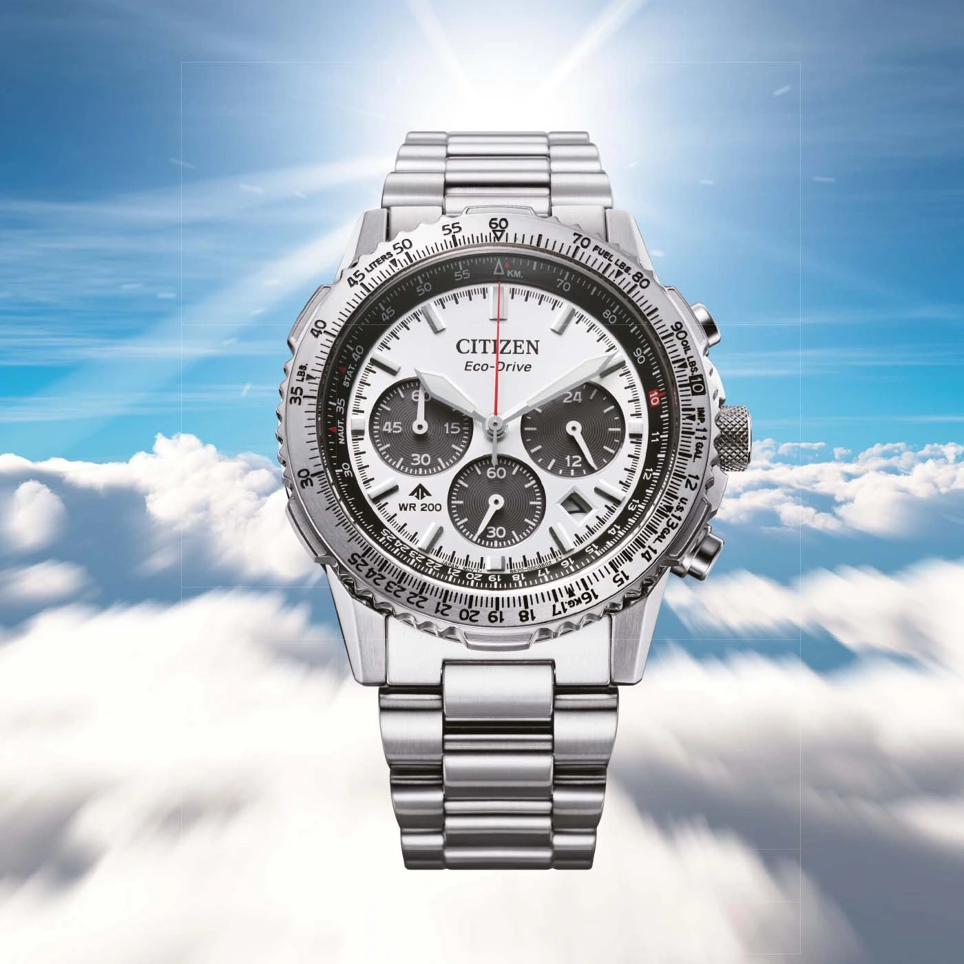 Citizen watch with white face, chronograph, and stainless steel band against a sky background.