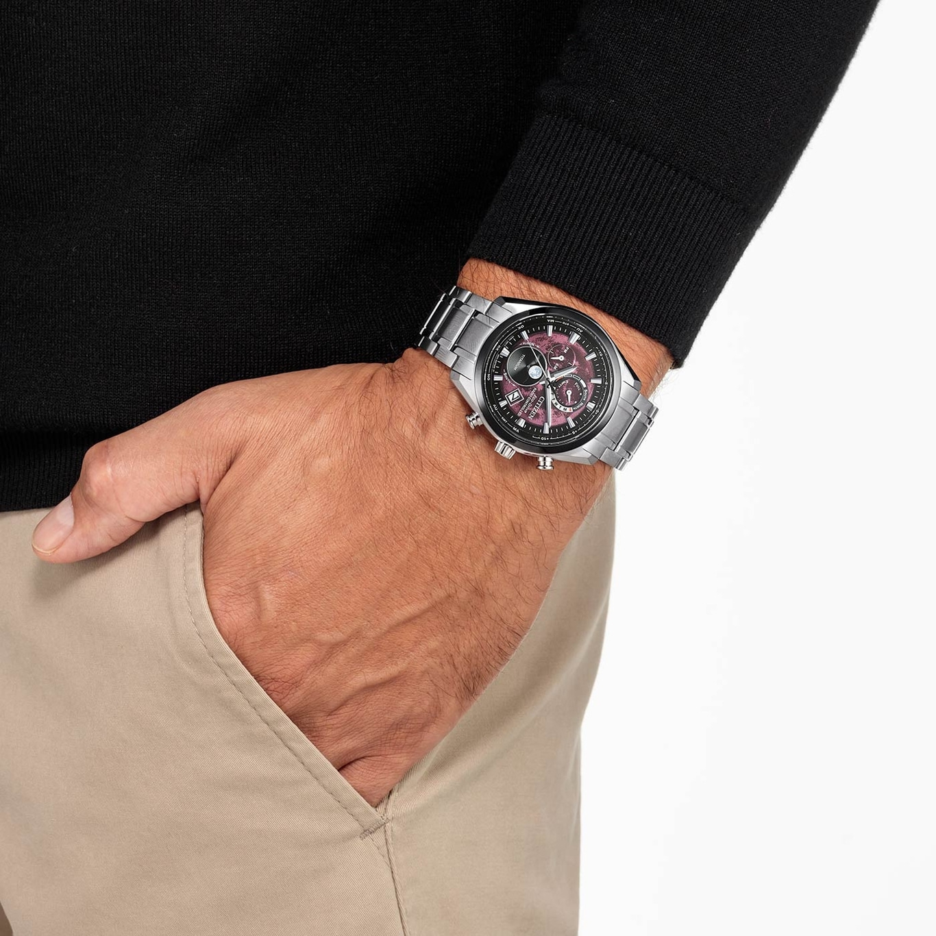 Man wearing a watch, hand in pocket, black sweater, beige pants, close-up shot