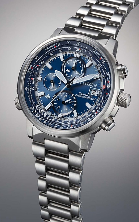 Citizen Eco-Drive watch with blue face and silver band, close-up shot.