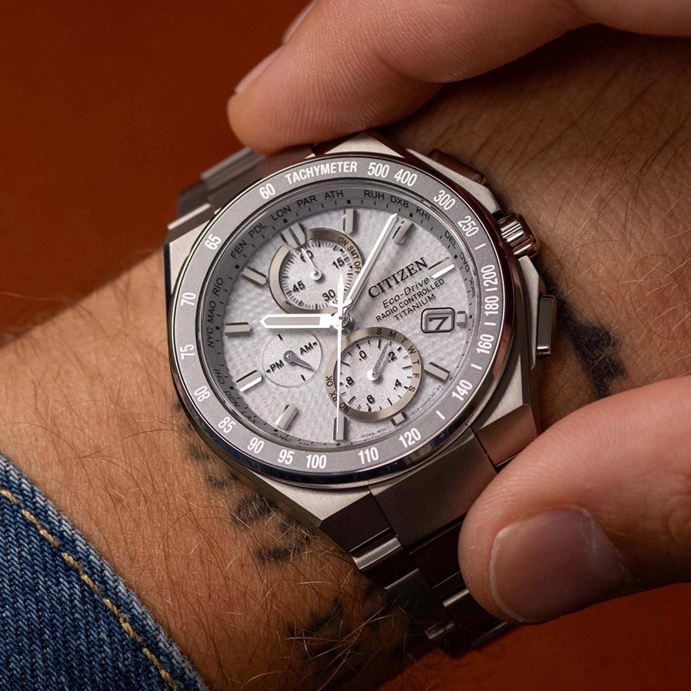 A man wears a Citizen Eco-Drive radio-controlled titanium watch on his wrist.