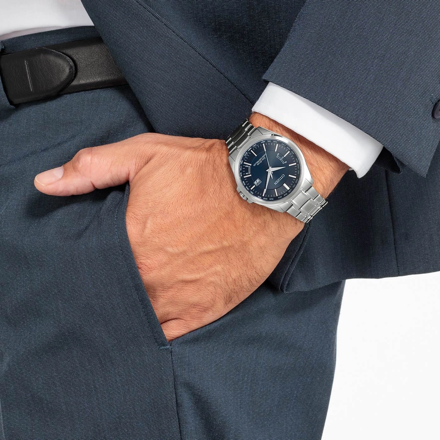 Man in suit with watch, hand in pocket, formal attire, business