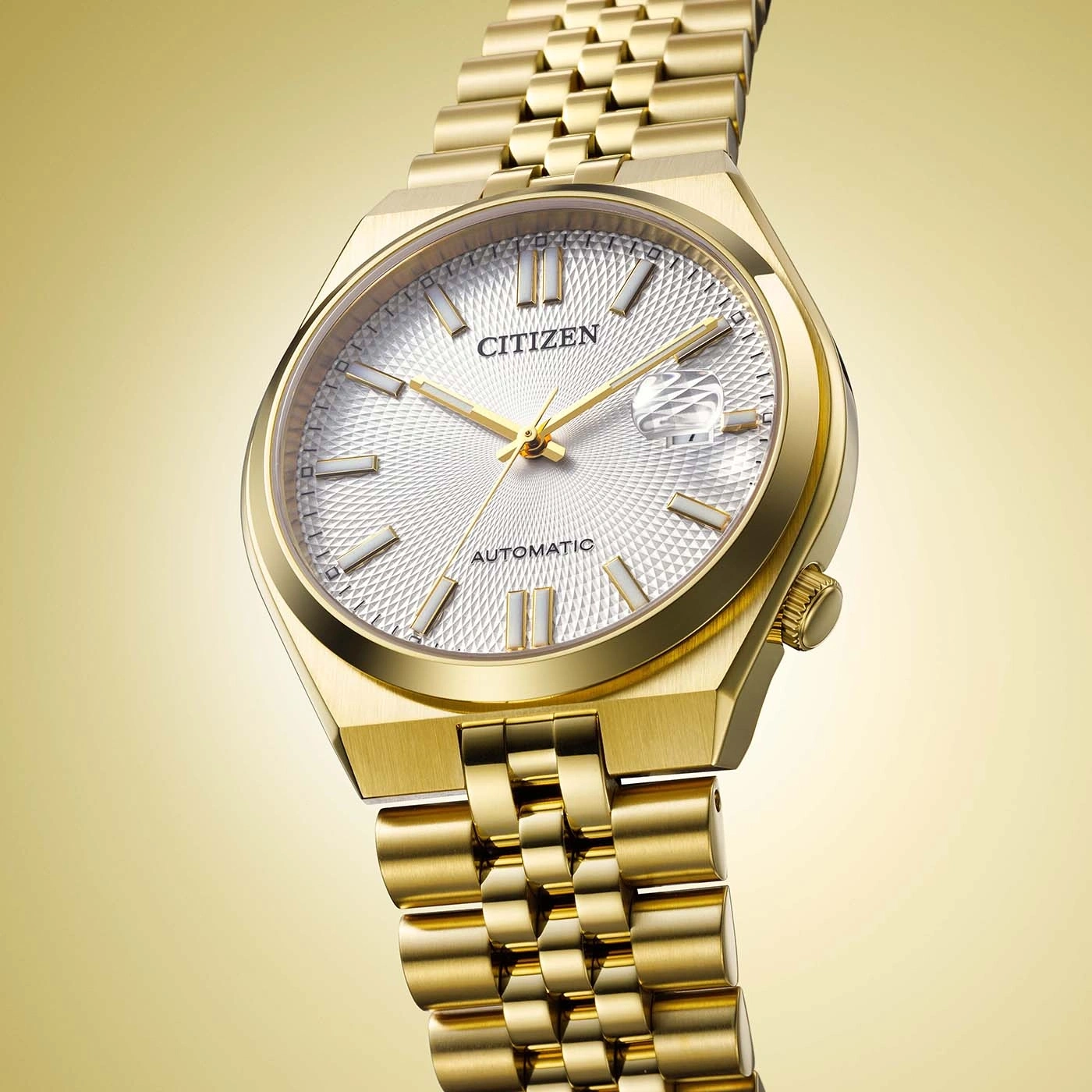 A gold Citizen automatic watch with a textured white dial.