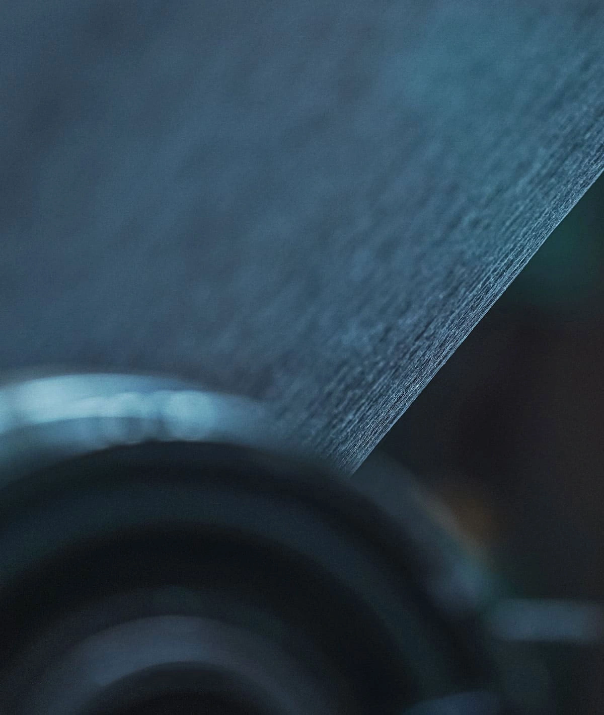 Close-up of a textured surface with a blurred background and dark tones.