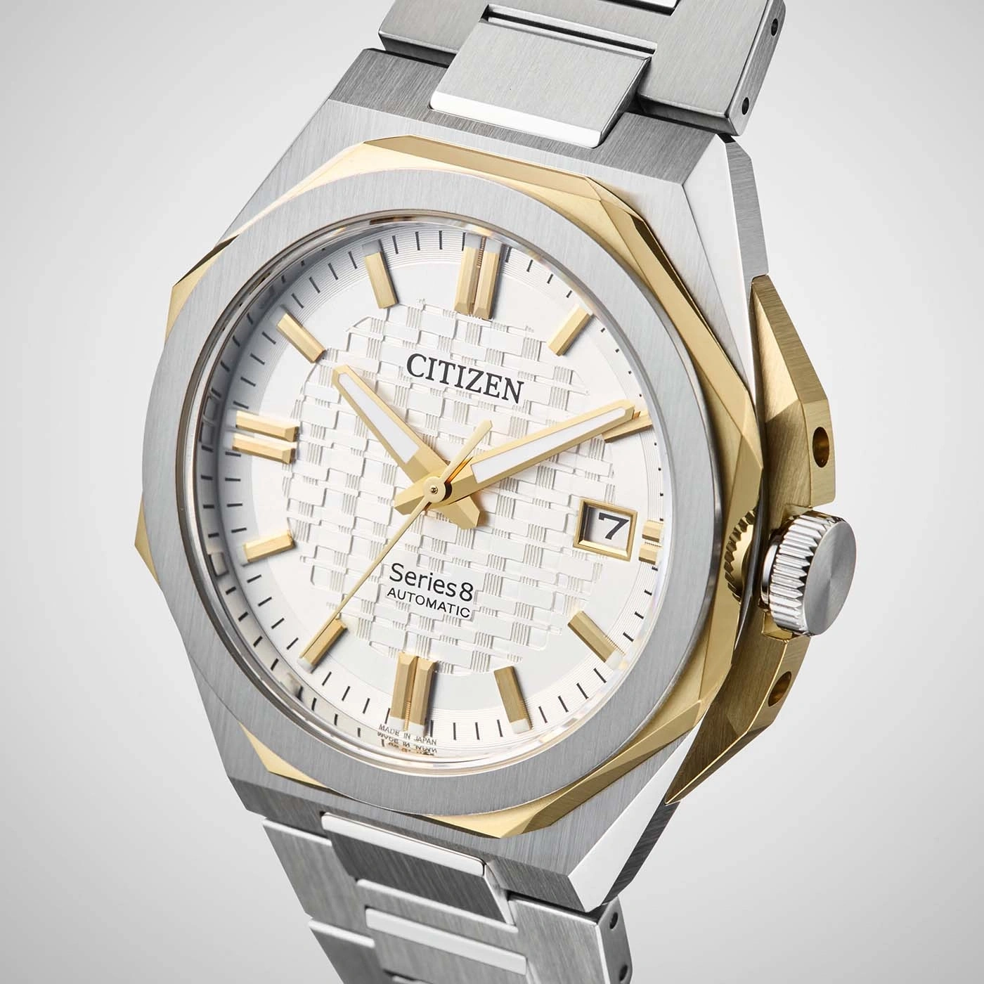 Close-up of a Citizen Series 8 automatic watch with a white textured dial and gold accents.