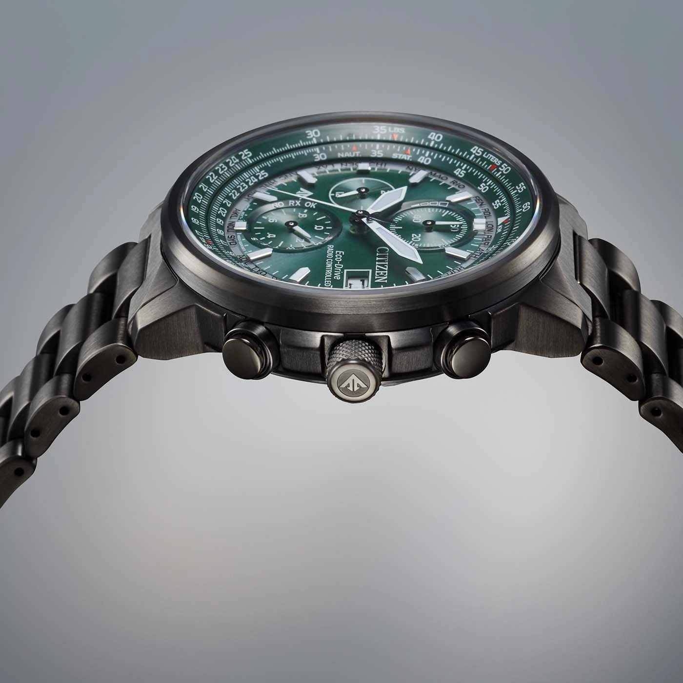 Citizen watch with green face and black band, close-up shot, time piece