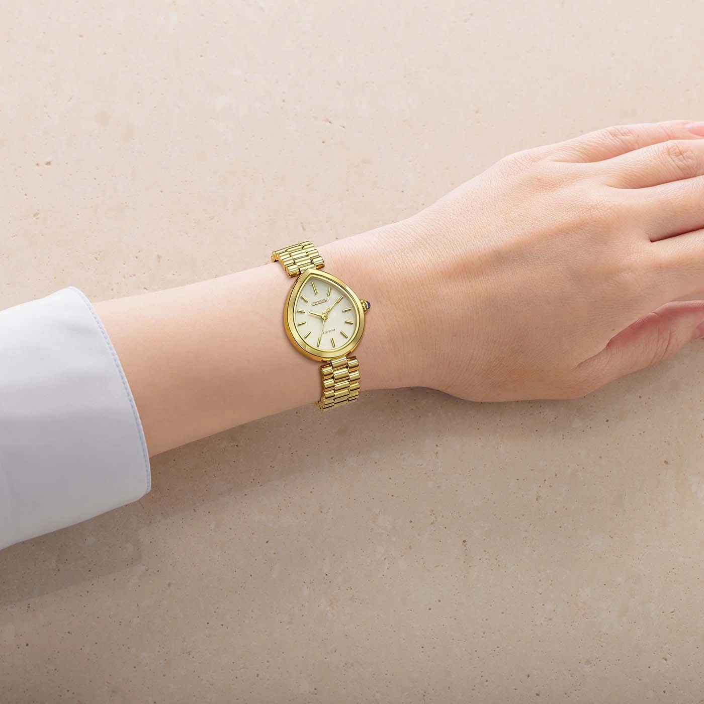 A gold watch on a woman's wrist